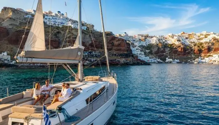 Romantic couple watching the famous Santorini sunset from a yacht deck