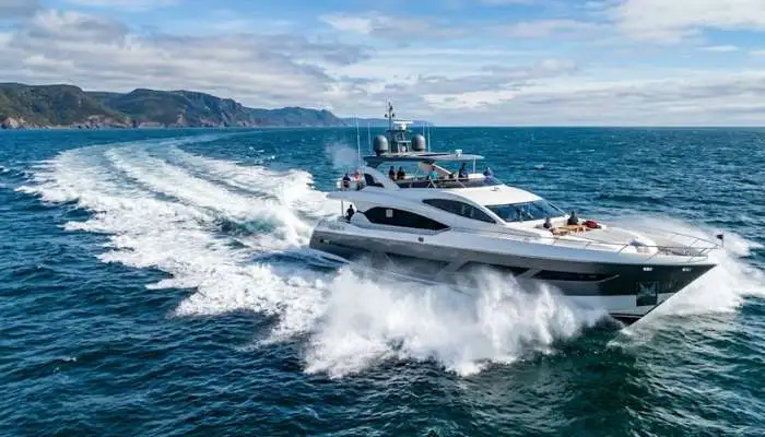 A high-speed motor yacht cruising through ocean waters at full speed